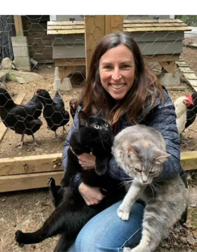 Dr. Melanie Sigetich with her two cats and chickens